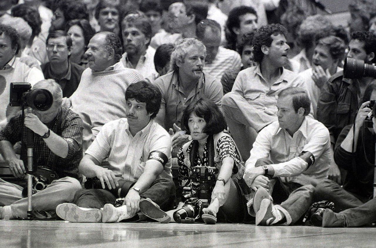 Wendy Maeda photographs the NBA Finals in 1985. She was one of the first Asian-American women to be hired as a full-time photojournalist on a newspaper staff. She covered news, features and sports for The Boston Globe. "She was like a sister to some of us," Yunghi Kim said.
