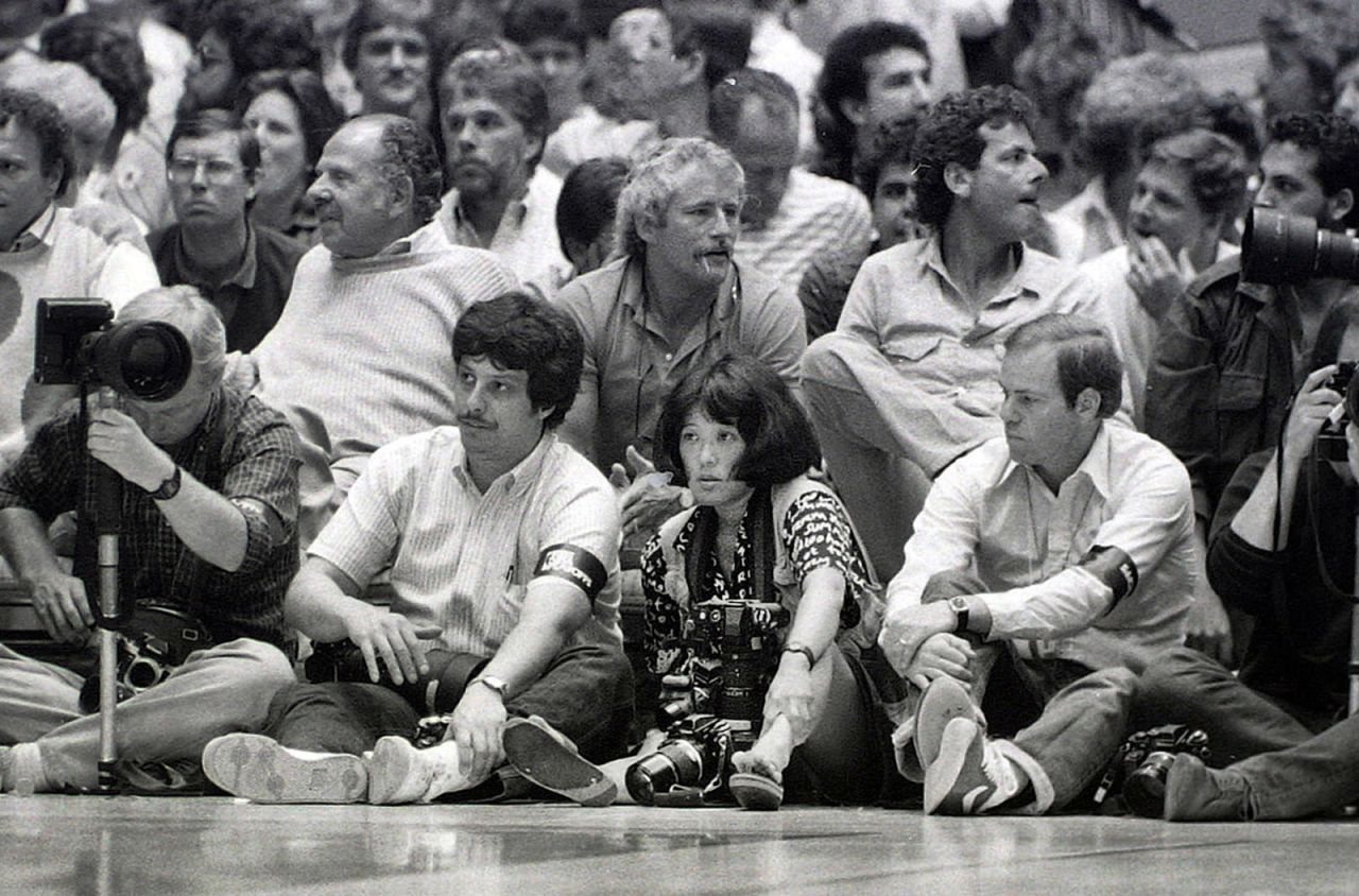 Wendy Maeda photographs the NBA Finals in 1985. She was one of the first Asian-American women to be hired as a full-time photojournalist on a newspaper staff. She covered news, features and sports for The Boston Globe. 