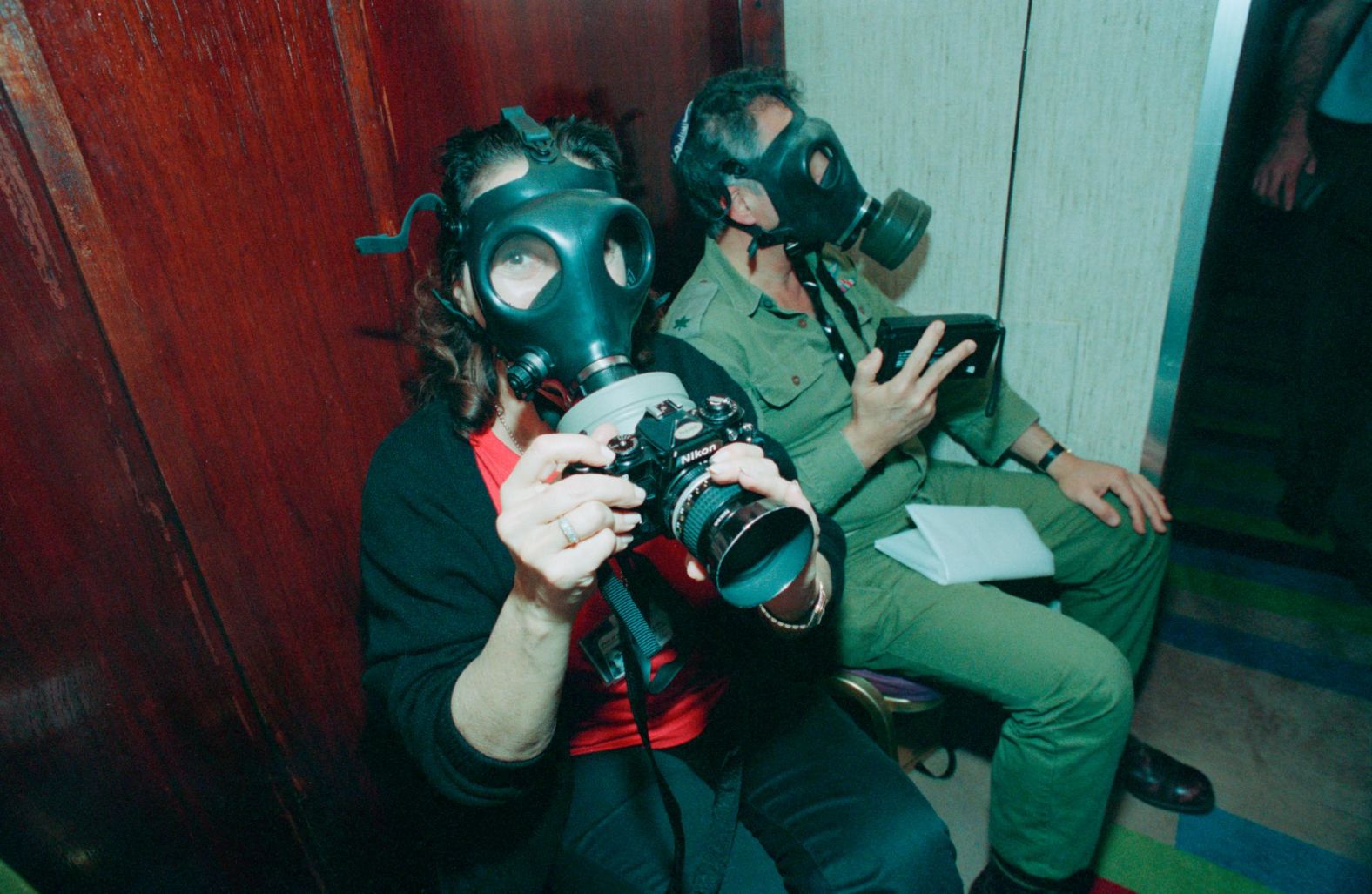 Sally Soames wears a gas mask in Israel following a missile attack by Iraq in 1991. The British photojournalist worked for The Observer and The Sunday Times newspapers, and her photos also appeared in other publications such as Newsweek and The New York Times. She worked in war zones but also took portraits of world leaders and celebrities such as Andy Warhol, Muhammad Ali and Sean Connery. When she photographed Ali, he told her <a href="index.php?page=&url=https%3A%2F%2Fwww.theguardian.com%2Fartanddesign%2F2019%2Foct%2F05%2Fnewspaper-photographer-sally-soames-dies-at-82" target="_blank" target="_blank">he had never met a female photographer before</a>.