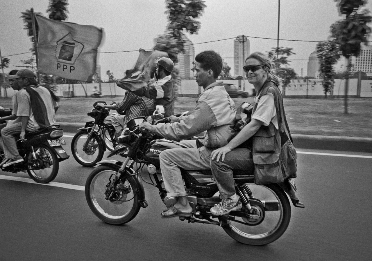 Paula Bronstein rides on the back of a motorbike in Jakarta, Indonesia, in 1998. Bronstein is based in Asia and has photographed many conflict areas over the past three decades. 