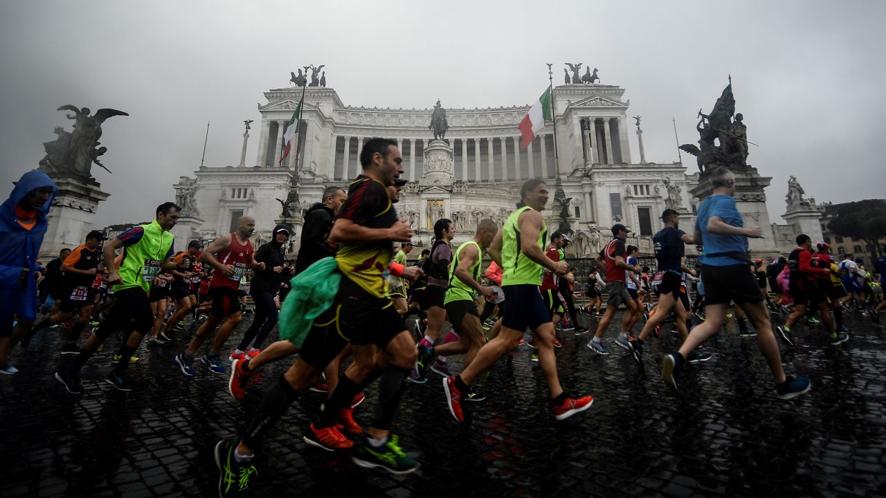Competitors run past the Altare della Patria monument after taking the start of the 25th edition of Rome Marathon on April 7, 2019 in Rome. 