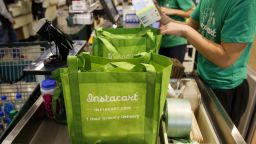 InstaCart employees fulfill orders for delivery at the new Whole Foods Market Inc. store in downtown Los Angeles, California, U.S., on Monday, Nov. 9, 2015. Located beneath the recently opened Eighth & Grand residences, the 41,000-square-foot store features a juice bar, fresh poke, expanded vegan options in all departments, a coffee bar (with cold brew on tap), more than 1,000 hand-picked wines, home delivery via Instacart and bar-restaurant The Eight Bar. Photographer: Patrick T. Fallon/Bloomberg via Getty Images