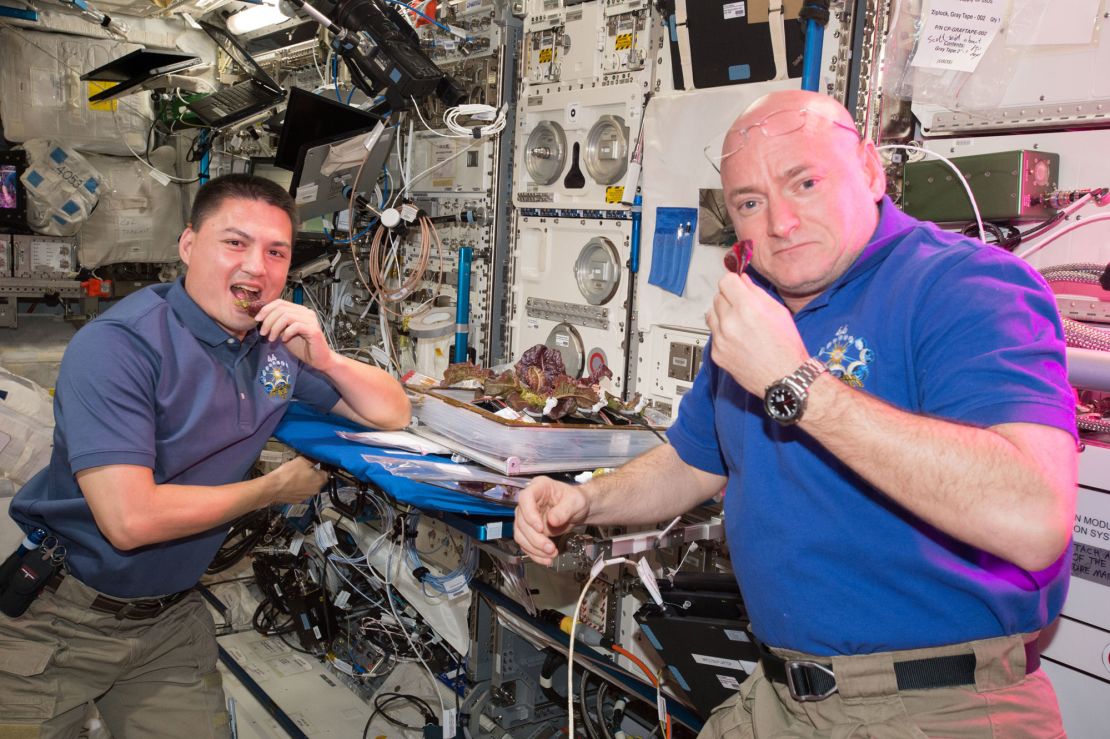 Astronauts Scott Kelly and Kjell Lindgren taste the lettuce grown onboard the station.