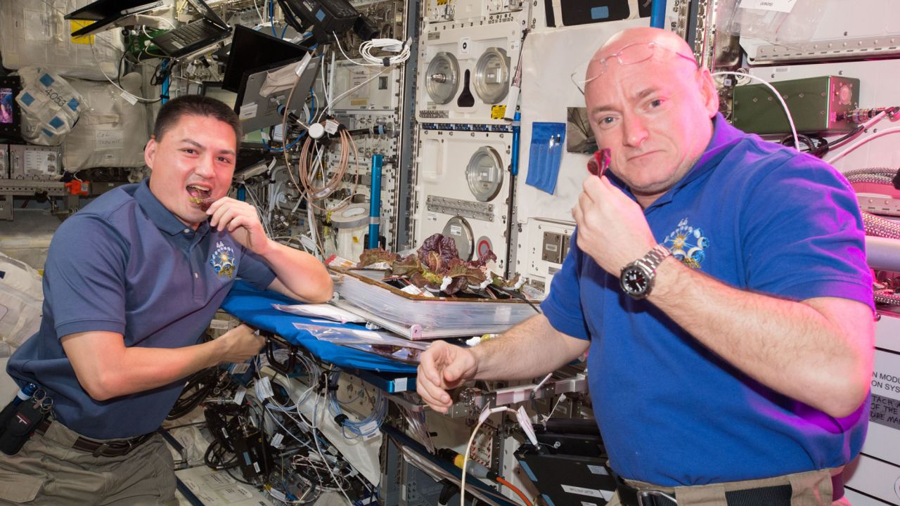 Astronauts Scott Kelly and Kjell Lindgren taste the lettuce grown onboard the station.