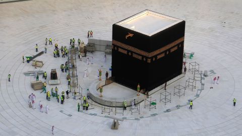 Workers clean the inside of Mecca's Grand Mosque on Thursday after Saudi Arabia emptied the holy site due to coronavirus fears. 