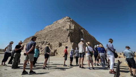 Tourists visist the step pyramid of Djoser in Egypt's Saqqara necropolis, south of the capital Cairo, on March 5, 2020. - Egyptian authorities inaugurated the famed step pyramid of Djoser,one of the earliest built in the country's ancient history, after years of renovation. The 4,700-year-old structure is nestled south of Cairo in the ancient capital of Memphis, a UNESCO World Heritage site, home to some of Egypt's most fascinating monuments. Renovation works started in 2006 but was interrupted in 2011 and 2012 for "security reasons" due to turmoil caused by a popular uprising that toppled late president Hosni Mubarak. (Photo by Mohamed el-Shahed / AFP) (Photo by MOHAMED EL-SHAHED/AFP via Getty Images)
