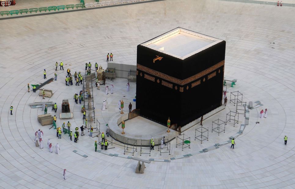 Municipal workers are seen at the Kaaba, inside Mecca's Grand Mosque. Saudi Arabia emptied Islam's holiest site for sterilization over coronavirus fears, an unprecedented move after the kingdom suspended the year-round Umrah pilgrimage.