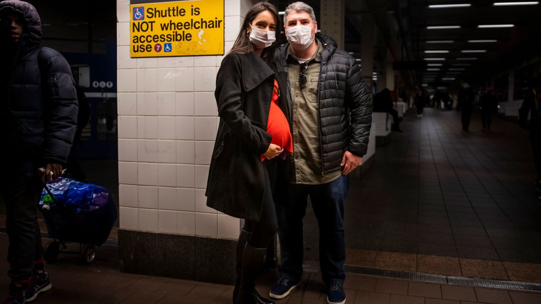 Leonardo Gayer and wife Vanessa, visiting from Brazil, wear surgical masks in the New York subway.