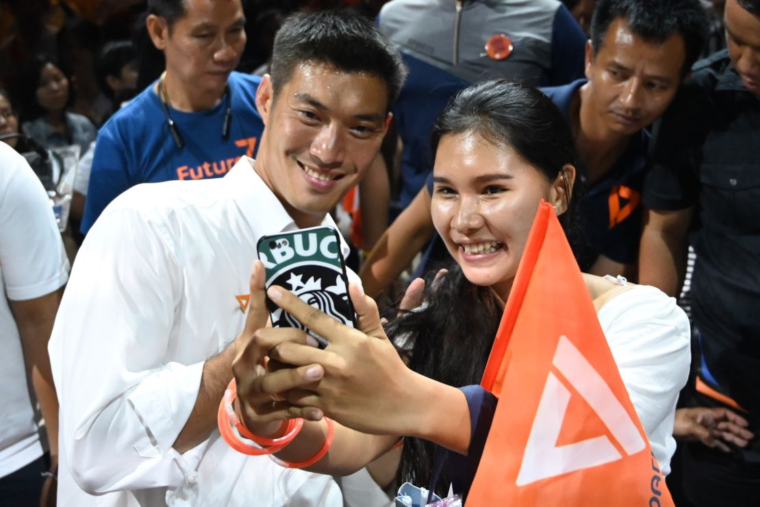 Future Forward Party leader Thanathorn Juangroongruangkit takes a selfie with a supporter in Bangkok on March 22, 2019.