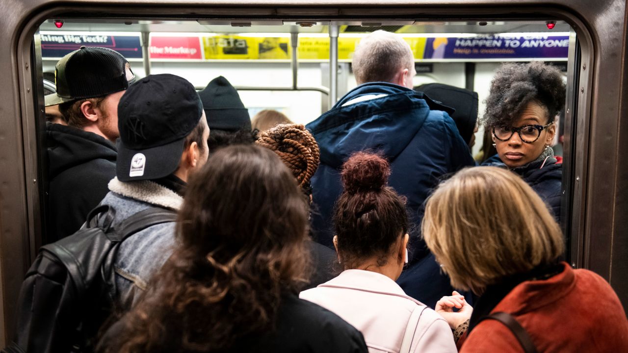 People push to board a crowded train in the New York City subway system during the start of diagnoses of the coronavirus in New York, U.S., on Thursday, March 5, 2020. CREDIT: Mark Kauzlarich for CNN