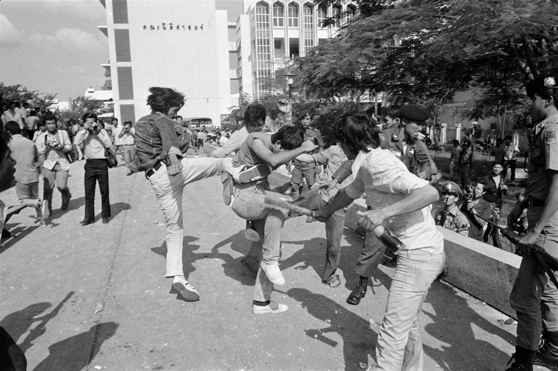 In this Oct. 6, 1976 file photo right-wing Thai students kick and beat a leftist student who surrendered after a battle on the campus of Thammasat  University in Bangkok, Thailand. 