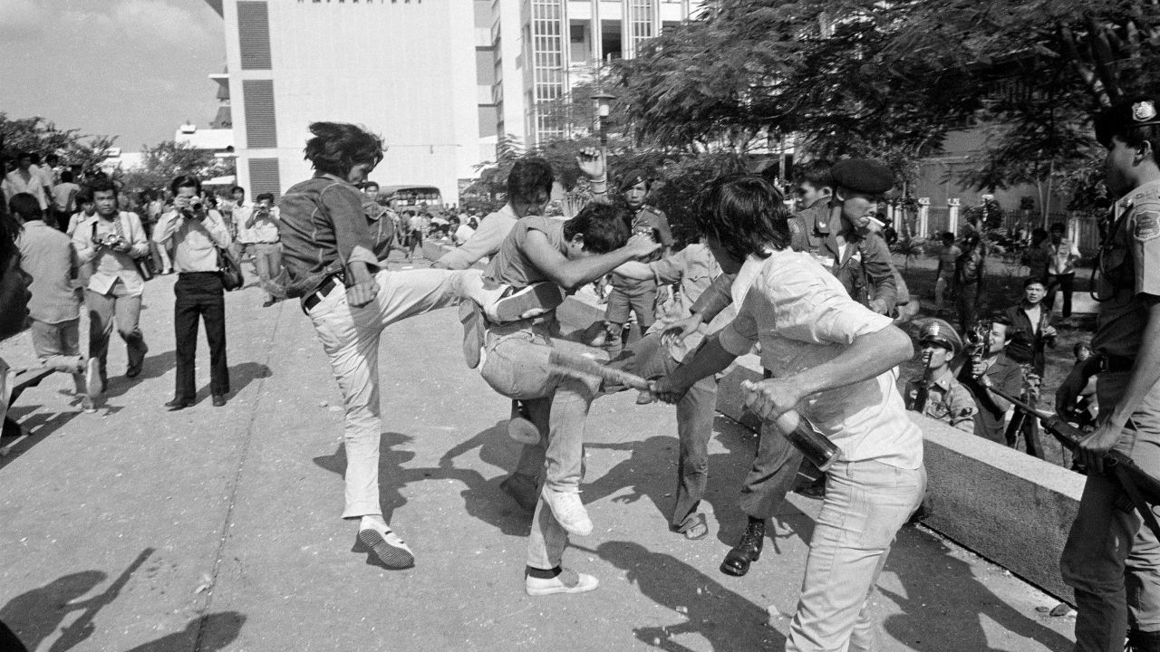 In this Oct. 6, 1976 file photo right-wing Thai students kick and beat a leftist student who surrendered after a battle on the campus of Thammasat  University in Bangkok, Thailand. 