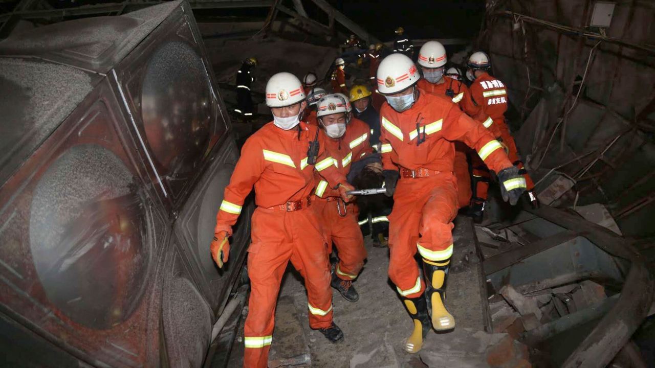 Rescuers evacuate an injured person from the rubble of a collapsed hotel building in Quanzhou city in southeast China's Fujian province.
