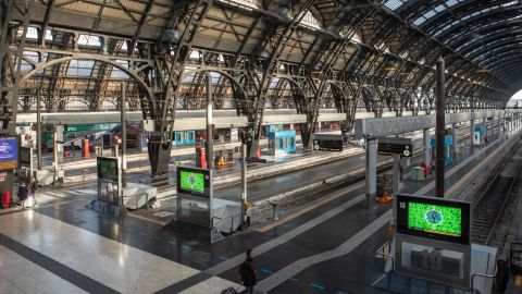 A woman walks in the almost deserted Central Station in Milan on Sunday after the lockdown was imposed overnight.