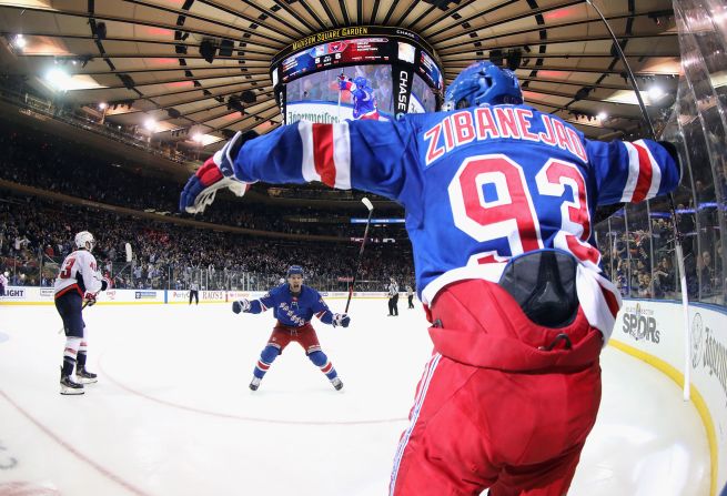 Mika Zibanejad, No. 93, and Tony DeAngelo, No. 77, of the New York Rangers celebrate Zibanejad's fifth goal of the game in overtime to defeat the Washington Capitals 5-4 at Madison Square Garden on March 5 in New York City.