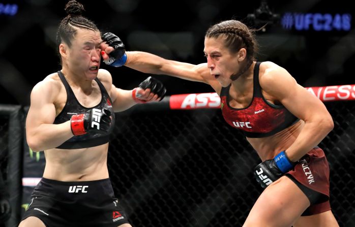 UFC women's strawweight champion Weili Zhang, left, takes a punch from former champion Joanna Jedrzejczyk during UFC 248 at T-Mobile Arena in Las Vegas on March 7.