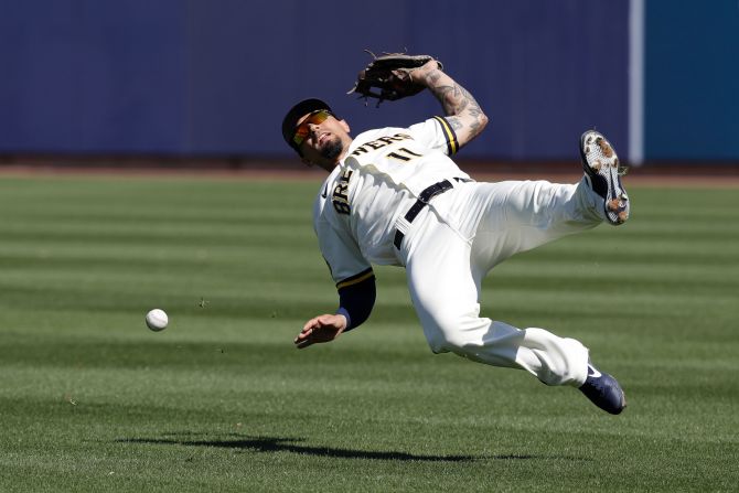 Milwaukee Brewers' Jace Peterson tries to catch a ball during the first inning of a spring training baseball game against the Cincinnati Reds on March 1 in Phoenix.