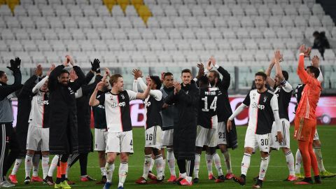 Juventus players applaud the empty stands after their win.