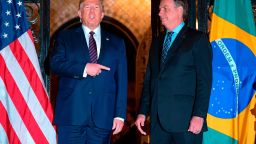 US President Donald Trump (L) speaks with Brazilian President Jair Bolsonaro during a dinner at Mar-a-Lago in Palm Beach, Florida, on March 7, 2020. (Photo by JIM WATSON / AFP) (Photo by JIM WATSON/AF