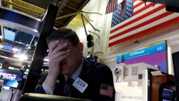Trader Michael Gallucci prepares for the day's activity on the floor of the New York Stock Exchange, Monday, March 9, 2020. Trading in Wall Street futures has been halted after they fell by more than the daily limit of 5%. (AP Photo/Richard Drew)