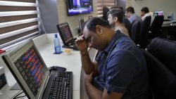 An Indian stockbroker reacts as he watches the Bombay Stock Exchange (BSE) index on a trading terminal in Mumbai, India, Monday, March 9, 2020. Global stock markets and oil prices plunged Monday after a squabble among crude producers jolted investors who already were on edge about the surging costs of a virus outbreak. India's Sensex retreated 6.2% to 35,255.73. (AP Photo/Rajanish Kakade)