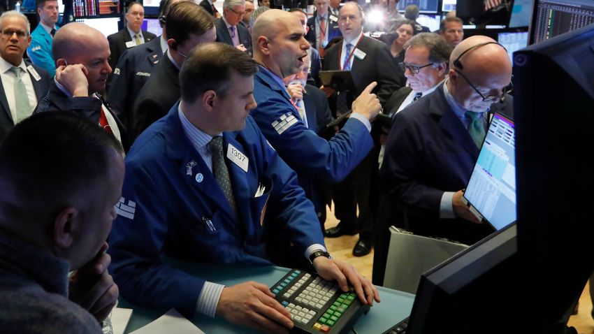 Specialist Philip Finale, background center, works with traders on the floor of the New York Stock Exchange, Monday, March 9, 2020. The Dow Jones Industrial Average plummeted 1,500 points, or 6%, following similar drops in Europe after a fight among major crude-producing countries jolted investors already on edge about the widening fallout from the outbreak of the new coronavirus. (AP Photo/Richard Drew)
