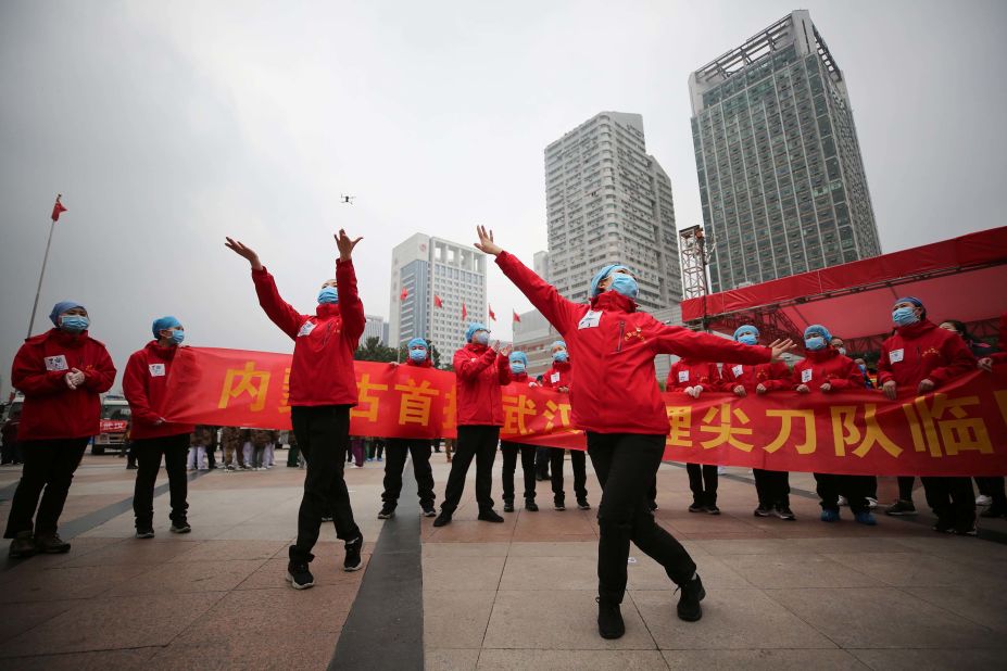 Medical staff in Wuhan, China, celebrate after all coronavirus patients were discharged from a temporary hospital on March 9, 2020.