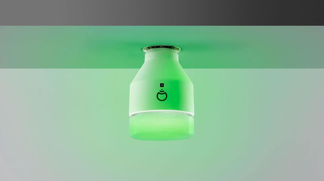 A LIFX smart bulb glowing green.