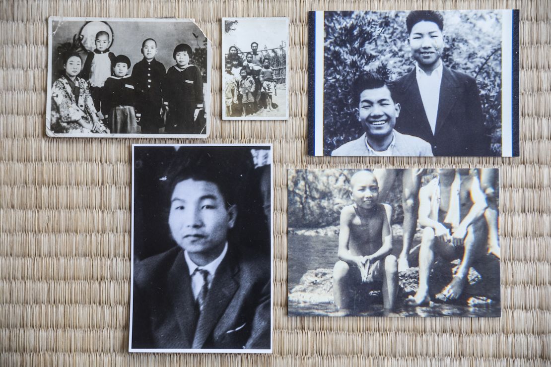 Photos of Iwao Hakamada spread along the tatami mat at his home in Hamamatsu.