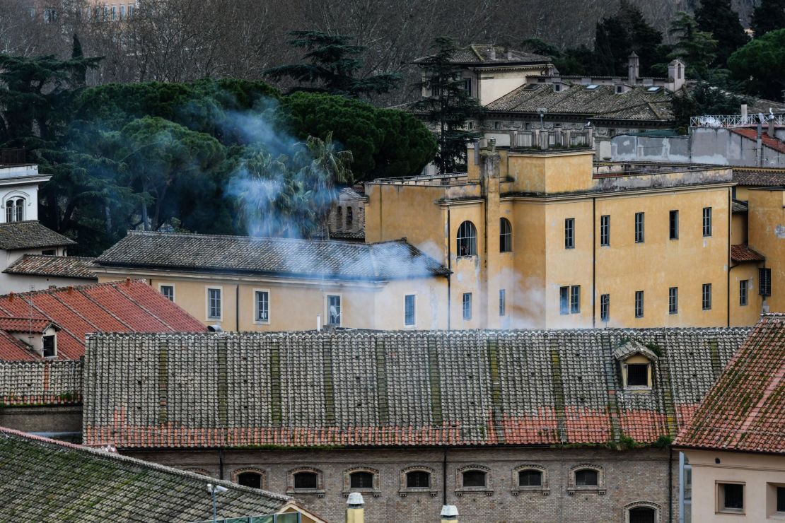 Smoke billows from a rooftop of the Regina Coeli prison in central Rome after protests in at least 22 prisons left 11 inmates dead.