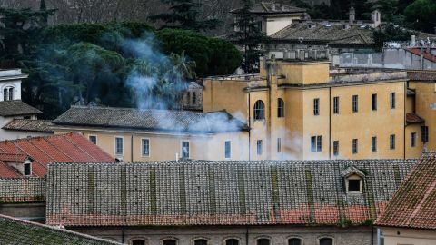 Smoke billows from a rooftop of the Regina Coeli prison in central Rome after protests in at least 22 prisons left 11 inmates dead.