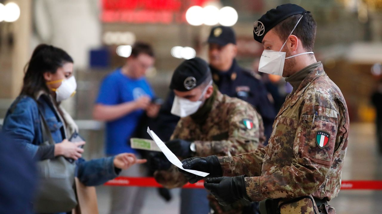 Police officers and soldiers check passengers leaving from Milan main train station, Italy, Monday, March 9, 2020. Italy took a page from China's playbook Sunday, attempting to lock down 16 million people — more than a quarter of its population — for nearly a month to halt the relentless march of the new coronavirus across Europe. Italian Premier Giuseppe Conte signed a quarantine decree early Sunday for the country's prosperous north. Areas under lockdown include Milan, Italy's financial hub and the main city in Lombardy, and Venice, the main city in the neighboring Veneto region.