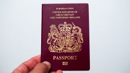 LONDON, UNITED KINGDOM - 2019/11/20: In this photo illustration a man holds a British passport in London.According to the Liberal Democrats manifesto, if they win the general election on 12 December 2019, British passports will feature an "X" option for people who identify as gender-neutral. (Photo Illustration by Dinendra Haria/SOPA Images/LightRocket via Getty Images)