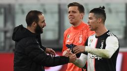 (FromL) Juventus' Argentinian forward Gonzalo Higuain, Juventus' Polish goalkeeper Wojciech Szczesny and Juventus' Portuguese forward Cristiano Ronaldo celebrate their victory over Inter Milan at the end of the Italian Serie A football match Juventus vs Inter Milan, at the Juventus stadium in Turin on March 8, 2020. - The match is played behind closed doors due to the novel coronavirus outbreak. (Photo by Vincenzo PINTO / AFP) (Photo by VINCENZO PINTO/AFP via Getty Images)