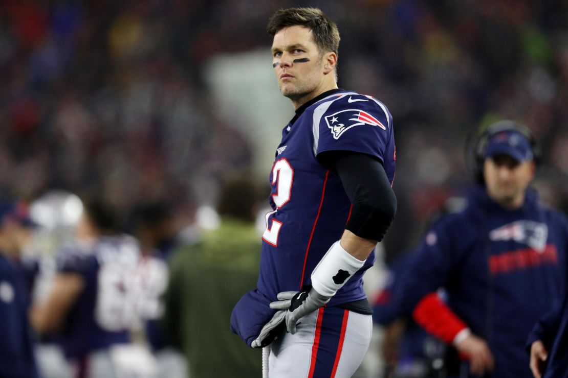 Brady looks on from the sideline during the the AFC Wild Card Playoff game against the Tennessee Titans.