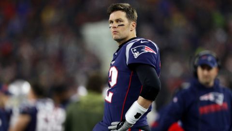 Brady looks on from the sideline during the the AFC Wild Card Playoff game against the Tennessee Titans.