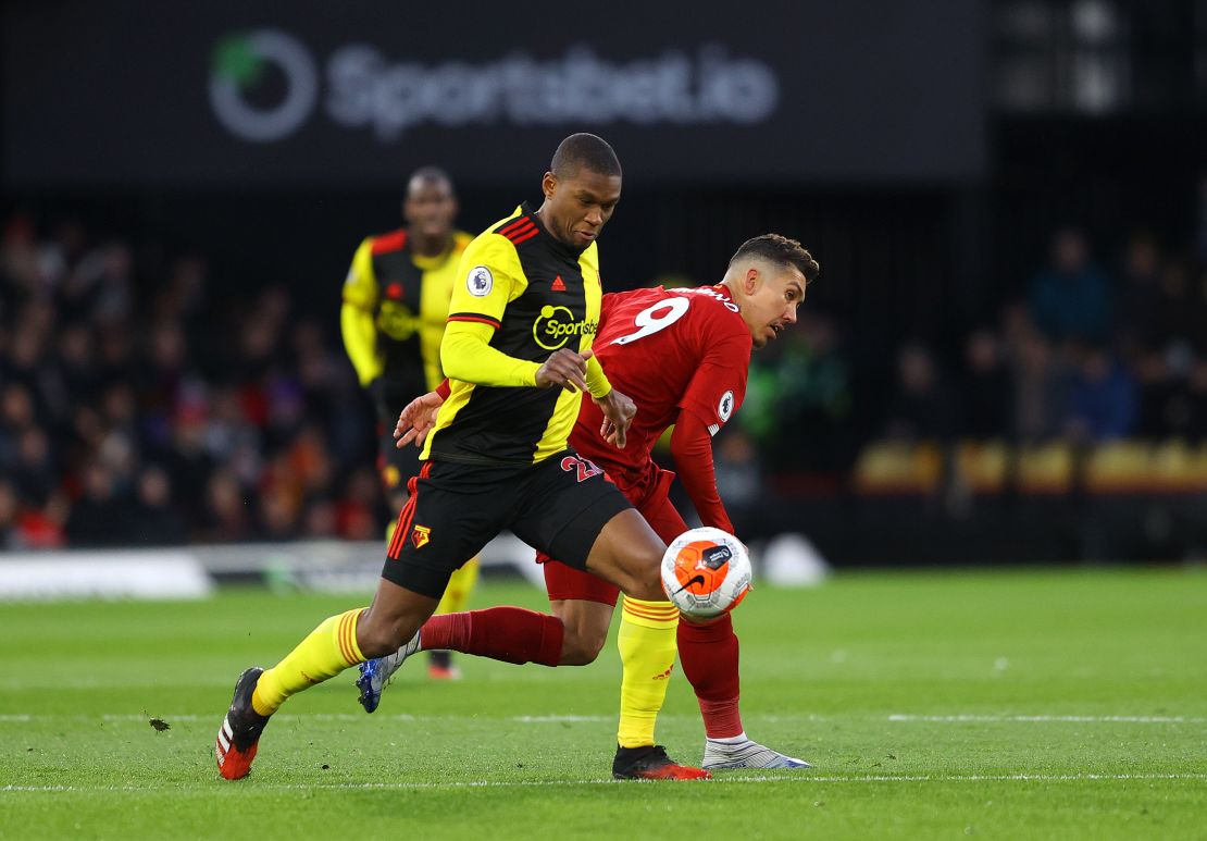 Kabasele battles for possession with Liverpool's Roberto Firmino.