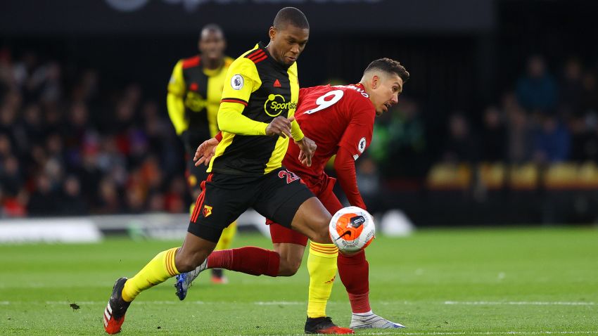 WATFORD, ENGLAND - FEBRUARY 29: Christian Kabasele of Watford battles for possession with Roberto Firmino of Liverpool during the Premier League match between Watford FC and Liverpool FC at Vicarage Road on February 29, 2020 in Watford, United Kingdom. (Photo by Richard Heathcote/Getty Images)