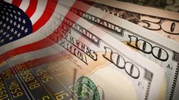 American flag and banknotes (USD) currency money on Stock market background.