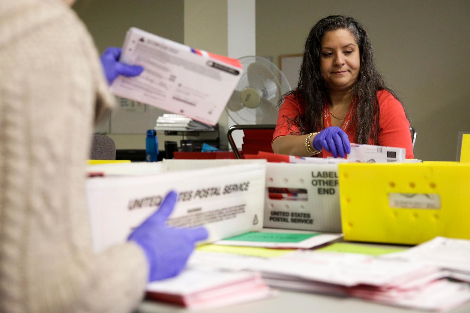 Workers use gloves to sort mail-in ballots in Renton, Washington, on Tuesday. Election officials mandated the precautionary measure <a href="index.php?page=&url=https%3A%2F%2Fwww.cnn.com%2F2020%2F03%2F09%2Fpolitics%2Fprimary-election-voter-turnout-coronavirus%2Findex.html" target="_blank">because of the coronavirus outbreak.</a>