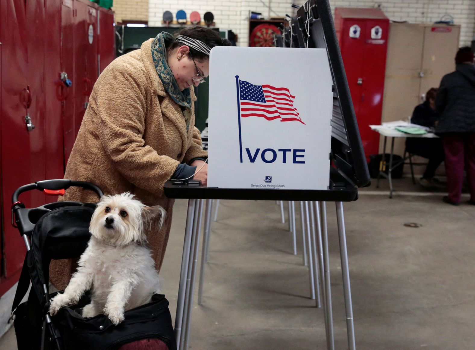 A voter is accompanied by a dog as she casts her ballot in Detroit.