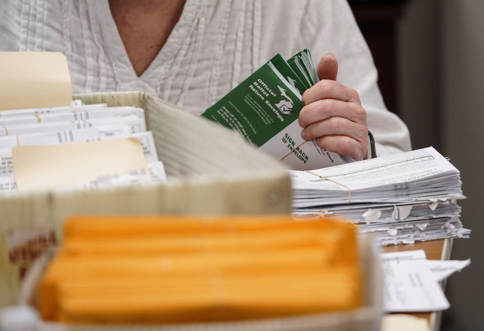 Election volunteers count absentee ballots in Livonia, Michigan, on Tuesday.