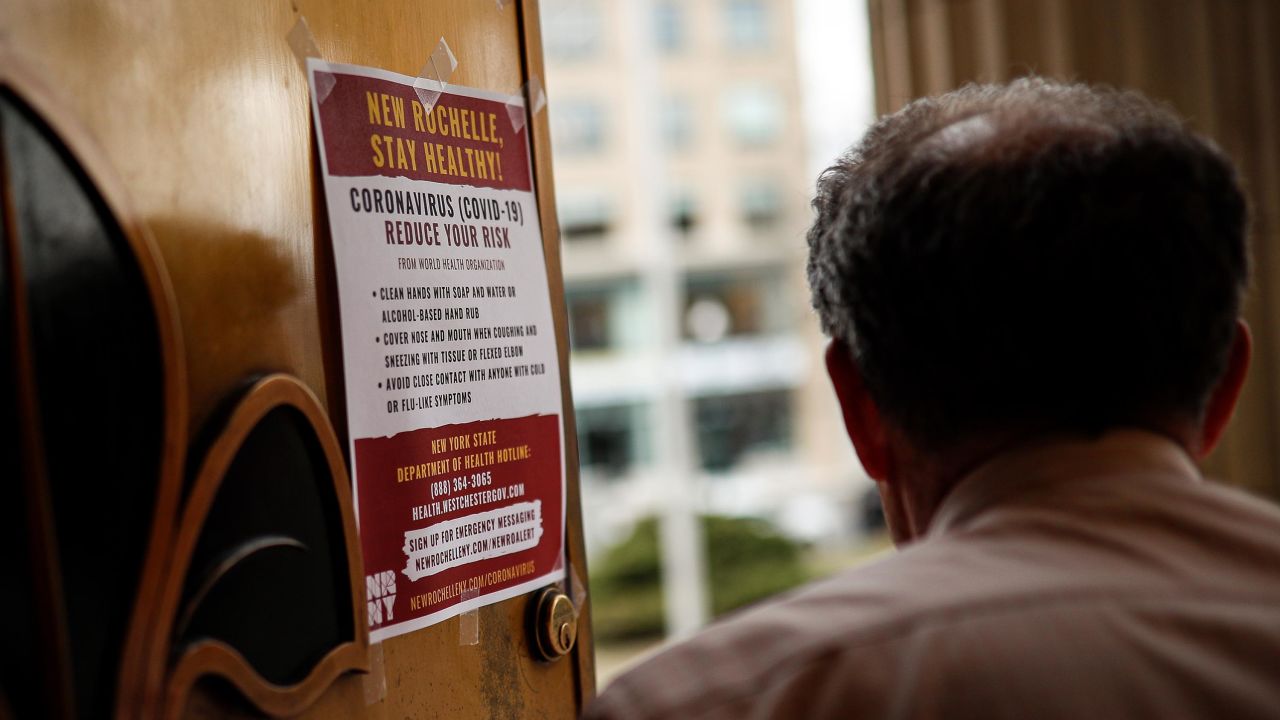 A sign providing instructions on how to reduce the risk of contracting or spreading COVID-19 is hung on the front door of New Rochelle City Hall, Tuesday, March 10, 2020, in New Rochelle, N.Y. State officials are shuttering schools and houses of worship for two weeks in part of the New York City suburb New Rochelle and sending the National Guard there to help respond to what appears to be the nation's biggest cluster of coronavirus cases.