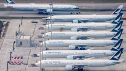 A Cathay Pacific passenger airplane (top) is taxied onto the runway as other aircrafts belonging to the local flagship carrier are seen parked on the tarmac at Hong Kong's Chek Lap Kok International Airport on March 10, 2020. Hong Kong's flagship carrier Cathay Pacific is expected to release its full-year financial results on March 11. 