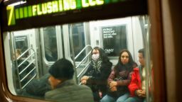 A woman wears a face mask as she rides the subway on March 8, 2020 in New York City. - The governor of New York on March 7, 2020 announced a state of emergency as the coronavirus continued to spread in the northeastern state, with 21 new cases. A total of 76 people have so far tested positive for the virus, Governor Andrew Cuomo told reporters in the state capital of Albany. Ten of those affected have been hospitalized. (Photo by Kena Betancur / AFP) (Photo by KENA BETANCUR/AFP via Getty Images)