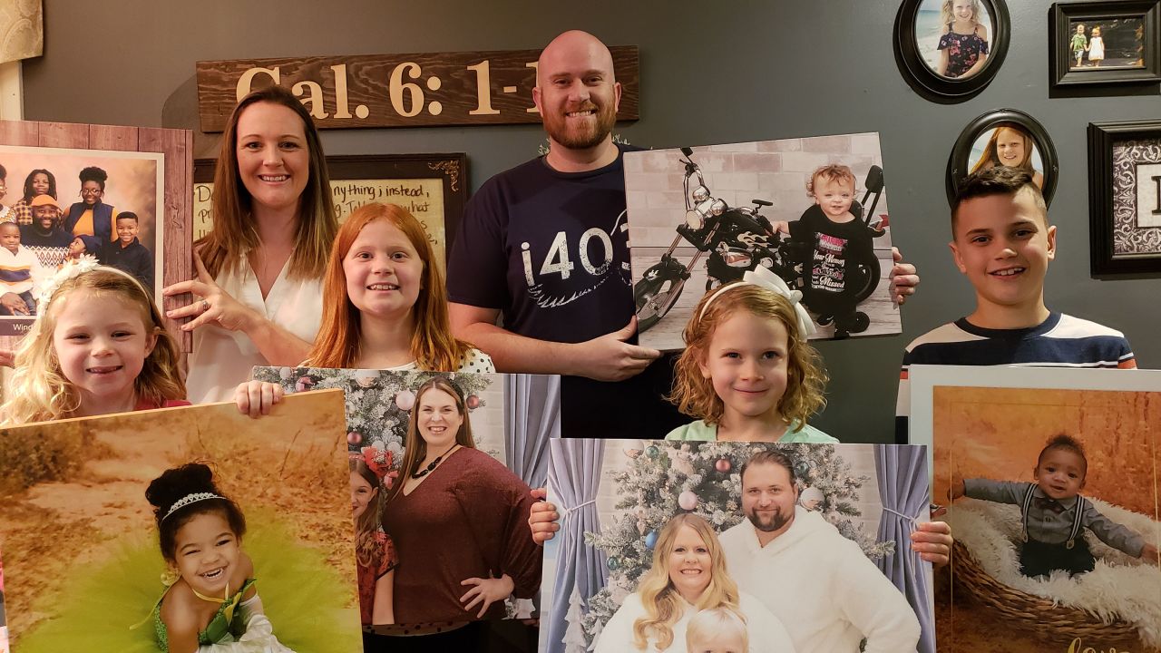 Brian Bononi with his family and the portraits he is helping get back.