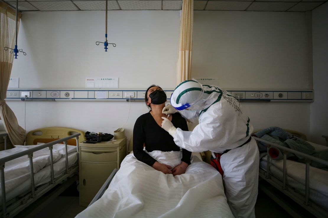 A patient infected by the COVID-19 coronavirus receives acupuncture treatment at Red Cross Hospital in Wuhan, China