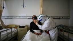 TOPSHOT - A patient (L) infected by the COVID-19 coronavirus receives acupuncture treatment at Red Cross Hospital in Wuhan in China's central Hubei province on March 11, 2020. - China reported an increase in imported coronavirus cases on March 11, fuelling concerns that infections from overseas could undermine progress in halting the spread of the virus. (Photo by STR / AFP) / China OUT (Photo by STR/AFP via Getty Images)