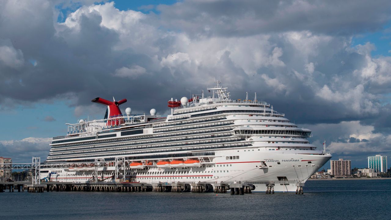 A Carnival Panorama cruise ship is seen docked in Long Beach, California on March 7, 2020, as passengers await onboard for the results of a COVID-19 (Coronavirus) test given to an ill passenger. - Long Beach city officials said on Twitter that a passenger aboard the cruise was taken to a local hospital by the Long Beach Fire Department and is being tested for the coronavirus. The ship is docked at a Long Beach terminal, but "in an abundance of caution, [the CDC] has decided to hold passengers on board until the patient can be evaluated." Siehara Kennedy, who is aboard the cruise ship, said passengers have been waiting more than three hours to disembark. Passengers are not being isolated in their rooms and have been allowed to gather in the ships bars and casino, she said. (Photo by Mark Ralston/AFP/Getty Images)