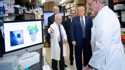 National Institute of Allergy and Infectious Diseases Director Tony Fauci (L) speaks to US President Donald Trump during a tour of the National Institutes of Health's Vaccine Research Center March 3, 2020, in Bethesda, Maryland. - The US Federal Reserve announced an emergency rate cut responding to the growing economic risk posed by the coronavirus epidemic after the UN health agency said the world has entered "uncharted territory" with the outbreak's rapid spread. (Photo by Brendan Smialowski/AFP/Getty Images)